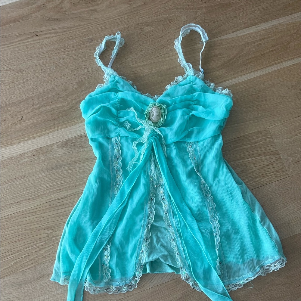 ‘Orange USA’ light turquoise tank top with fine detailing and stretchy material.